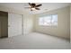 Spacious bedroom with neutral paint, large window, closet, and carpet flooring at 6276 S Robertsdale Ct, Aurora, CO 80016