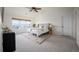 Comfortable bedroom featuring a large window, a cozy bed with decorative pillows, and neutral decor at 6276 S Robertsdale Ct, Aurora, CO 80016
