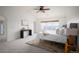 Bright bedroom featuring a neutral color scheme, vaulted ceiling, and a cozy seating area at 6276 S Robertsdale Ct, Aurora, CO 80016
