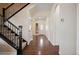 Inviting hallway with hardwood floors, a staircase, and a front door with decorative glass at 6276 S Robertsdale Ct, Aurora, CO 80016