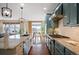 Stylish kitchen featuring granite countertops, stainless steel appliances, hardwood floors, and views into the living area at 6276 S Robertsdale Ct, Aurora, CO 80016