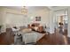 Inviting living room features a leather sofa, stylish chairs, a modern rug, and hardwood floors at 6276 S Robertsdale Ct, Aurora, CO 80016
