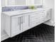Modern bathroom vanity with double sinks, sleek hardware, and mosaic tile backsplash at 3801 S Albion St, Englewood, CO 80113