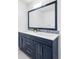 Stylish bathroom vanity with double sinks, large mirror, and decorative backsplash at 3801 S Albion St, Englewood, CO 80113