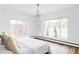 Light-filled bedroom with hardwood floors, a chandelier, and ample natural light at 3801 S Albion St, Englewood, CO 80113