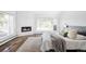 Cozy bedroom featuring fireplace, area rug, and a large window overlooking nature at 3801 S Albion St, Englewood, CO 80113