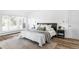 Well-lit bedroom with hardwood floors, modern furniture, and a large window at 3801 S Albion St, Englewood, CO 80113