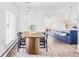 Dining area features a wood table, black chairs, and modern lighting fixture above at 3801 S Albion St, Englewood, CO 80113