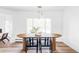 Bright dining room with wood table, black chairs, and large windows, providing ample natural light at 3801 S Albion St, Englewood, CO 80113