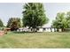 Beautiful home exterior with a large front yard and mature trees at 3801 S Albion St, Englewood, CO 80113