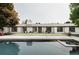 Stunning home exterior with a pool, white facade, and a well-manicured lawn, perfect for outdoor living and entertaining at 3801 S Albion St, Englewood, CO 80113