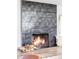 Modern fireplace with stylish tile surround, creating a warm and inviting focal point in the living space with hardwood flooring at 3801 S Albion St, Englewood, CO 80113