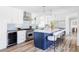 Bright, modern kitchen with stainless steel appliances, island seating, and elegant cabinetry, perfect for cooking and entertaining at 3801 S Albion St, Englewood, CO 80113