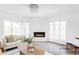 Bright living room with modern fireplace, two couches, a chair, and light-colored walls at 3801 S Albion St, Englewood, CO 80113