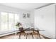 Bright home office with a glass desk and large window at 3801 S Albion St, Englewood, CO 80113
