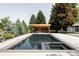 Beautiful backyard pool with a covered lounge area at 3801 S Albion St, Englewood, CO 80113