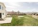 Large backyard with a patio, wooden fence, play set and mountain views at 9665 Bighorn Way, Littleton, CO 80125