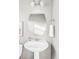 Bathroom with a pedestal sink, oval mirror, and chrome fixtures at 9665 Bighorn Way, Littleton, CO 80125