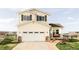Charming two-story home featuring a spacious two-car garage and a welcoming front porch at 9665 Bighorn Way, Littleton, CO 80125