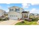 Charming two-story home featuring a spacious two-car garage and a welcoming front porch with stone accents at 9665 Bighorn Way, Littleton, CO 80125