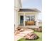 Inviting front porch with swing bench, stone accents, and landscaped entryway at 9665 Bighorn Way, Littleton, CO 80125