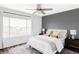 Comfortable main bedroom with a neutral palette, large window, and ceiling fan at 9665 Bighorn Way, Littleton, CO 80125