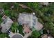 Aerial view of a home showcasing the well-manicured lawn, basketball court, and stone roof at 11362 W Baltic Ct, Lakewood, CO 80227