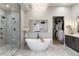 Elegant bathroom with a freestanding tub, a glass-enclosed shower, and a walk-in closet at 11362 W Baltic Ct, Lakewood, CO 80227