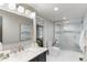 Bright bathroom featuring a spacious glass shower, modern fixtures, and stylish tilework at 11362 W Baltic Ct, Lakewood, CO 80227