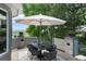 Outdoor dining space with a modern table, chairs, and an umbrella with mountain views at 11362 W Baltic Ct, Lakewood, CO 80227