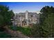 Stunning exterior view of a multi-story home surrounded by lush greenery and mature trees at 11362 W Baltic Ct, Lakewood, CO 80227