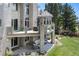 Multi-level deck with stone pillars featuring an outdoor living space and lush backyard at 11362 W Baltic Ct, Lakewood, CO 80227