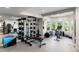 Home gym featuring a full range of equipment, mirrors, and windows that offer natural light and views of the outdoors at 11362 W Baltic Ct, Lakewood, CO 80227