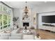 Cozy living room with a white brick fireplace, plush seating, and ample natural light at 11362 W Baltic Ct, Lakewood, CO 80227