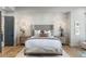 Luxurious main bedroom with accent wall, tufted headboard, and bench at 11362 W Baltic Ct, Lakewood, CO 80227