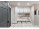 Bright mudroom features built-in storage, bench with marble countertop, and decorative marble backsplash at 11362 W Baltic Ct, Lakewood, CO 80227