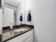 Clean half bathroom featuring modern fixtures, stylish vanity, and a framed mirror at 1294 S Troy St, Aurora, CO 80012