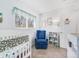 Comfortable Bedroom with a navy rocking chair and a bookshelf at 1294 S Troy St, Aurora, CO 80012