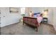 Cozy bedroom with a wood-framed bed, soft carpet, and natural lighting at 1294 S Troy St, Aurora, CO 80012