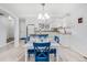 Well-lit dining area with a view of the updated kitchen featuring white cabinets and granite countertops at 1294 S Troy St, Aurora, CO 80012