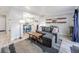 Inviting living room with comfortable gray sofa, stylish rug, and open view into the dining and kitchen areas at 1294 S Troy St, Aurora, CO 80012