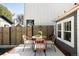 Cozy back patio features a stylish wicker table set and charming string lights at 3842 Zenobia St, Denver, CO 80212