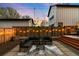 Backyard with patio, modern furniture, deck, and string lights at dusk at 3842 Zenobia St, Denver, CO 80212