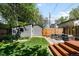 Grassy backyard with shed, patio, modern furniture, and wooden fence at 3842 Zenobia St, Denver, CO 80212