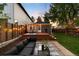 Landscaped backyard with a patio, lounge area, and string lights, ideal for outdoor living at 3842 Zenobia St, Denver, CO 80212