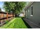 Well-maintained backyard with a lush green lawn and wooden fence at 3842 Zenobia St, Denver, CO 80212