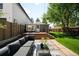 Backyard with patio, deck, modern outdoor furniture, and lush lawn at 3842 Zenobia St, Denver, CO 80212