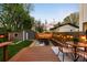 Backyard with deck, modern furniture, garden, and string lights at 3842 Zenobia St, Denver, CO 80212