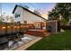 Spacious backyard featuring a deck, modern furniture, and a well-kept lawn at 3842 Zenobia St, Denver, CO 80212