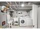 Basement laundry area with modern washer, dryer, and utility sink at 3842 Zenobia St, Denver, CO 80212